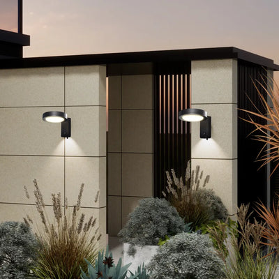 solar led wall light with movement sensor setting with wall-mounted lights and decorative plants.