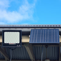 Solar sensor floodlight illuminating an outdoor area, showcasing its eco-friendly design and functionality.